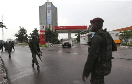 Congolese security forces secure the street near the state television headquarters in the capital Kinshasa, December 30, 2013. REUTERS/Jean Robert N'Kengo