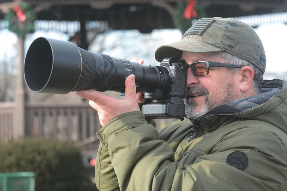 Jeff Vlaun of Norwich uses a 500-millimeter lens to photograph bald eagles Monday at Howard T. Brown Memorial Park in downtown Norwich.