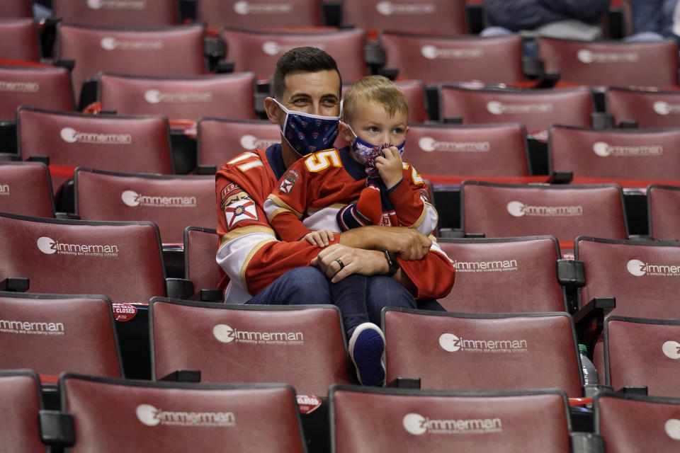 Florida Panthers fans watch in a socially distanced arena during the third period of an NHL hockey game against the Dallas Stars, Monday, Feb. 22, 2021, in Sunrise, Fla. The Panthers won 3-1. (AP Photo/Lynne Sladky)