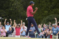 Tony Finau celebrates his victory over Sebastian Munoz, of Colombia, on the 17th green during their singles match at the Presidents Cup golf tournament at the Quail Hollow Club, Sunday, Sept. 25, 2022, in Charlotte, N.C. (AP Photo/Chris Carlson)