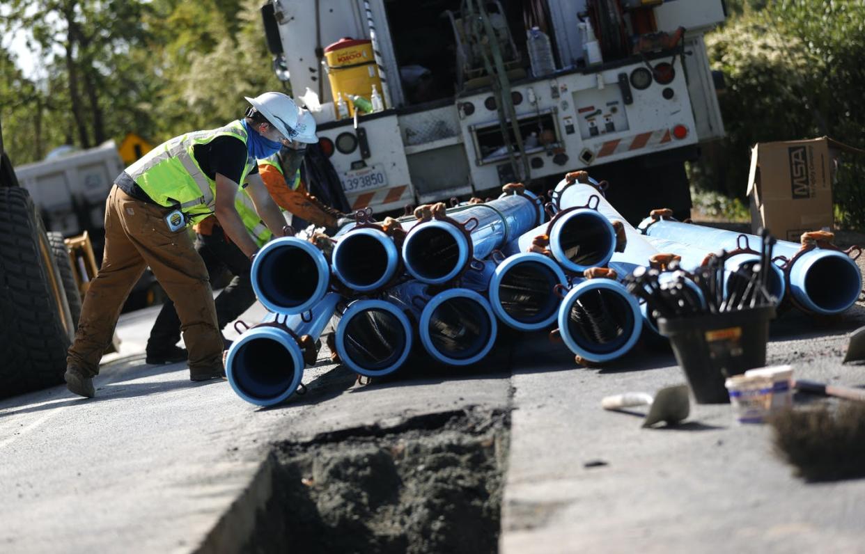 <span class="caption">Workers prepare to install new water pipes in Walnut Creek, California, on April 22, 2021.</span> <span class="attribution"><a class="link " href="https://www.gettyimages.com/detail/news-photo/workers-with-east-bay-municipal-utility-district-stack-news-photo/1313906917" rel="nofollow noopener" target="_blank" data-ylk="slk:Justin Sullivan/Getty Images;elm:context_link;itc:0;sec:content-canvas">Justin Sullivan/Getty Images</a></span>