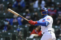 Chicago Cubs Javier Baez watches his three-run home run during the third inning of a baseball game against the Atlanta Braves Saturday, April 17, 2021, in Chicago. (AP Photo/Paul Beaty)