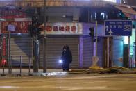 A police technician looks for explosive devices after a protest in the Mong Kok area in Hong Kong