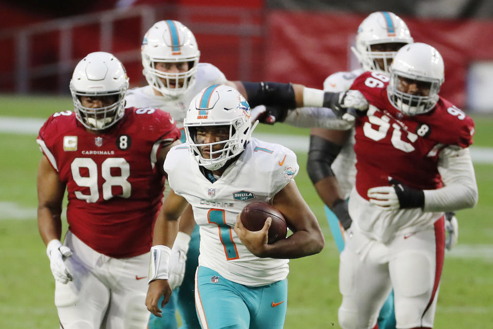 Tua Tagovailoa #1 of the Miami Dolphins carries the ball as Corey Peters #98 of the Arizona Cardinals gives chase during the second half at State Farm Stadium on November 08, 2020 in Glendale, Arizona. (Photo by Chris Coduto/Getty Images)