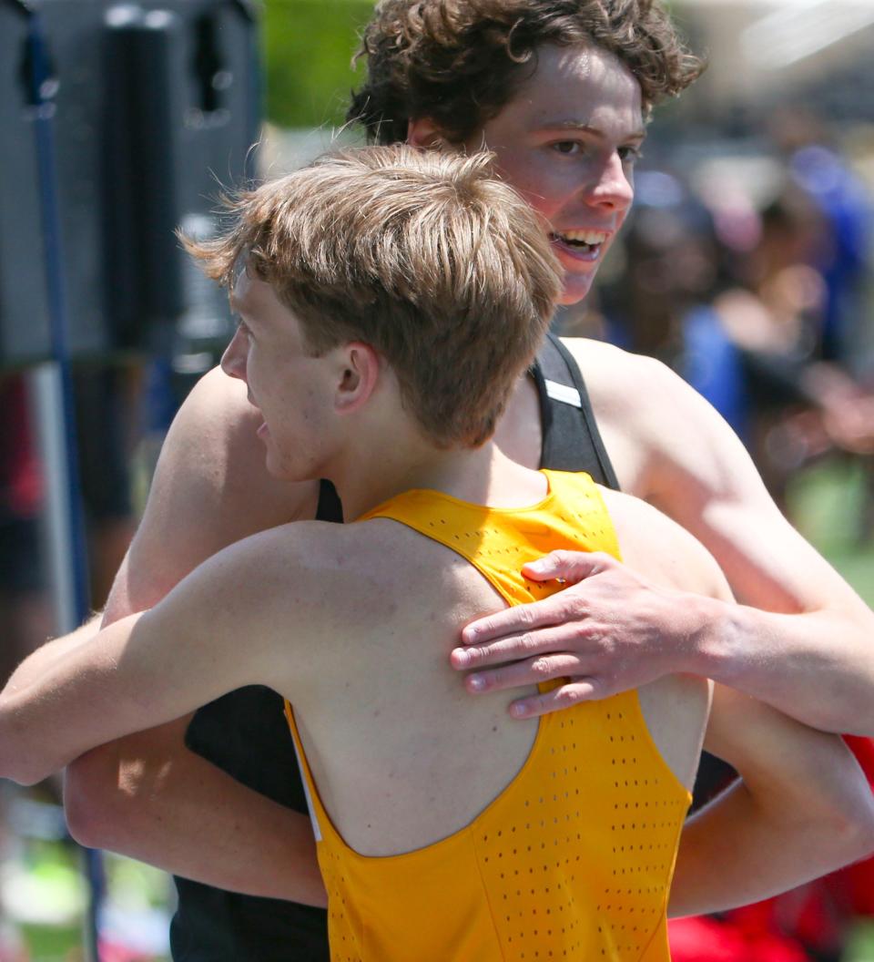 Winner Ethan Walther of Salesianum (front) and second place Ben Pizarro of Tatnall congratulate each other after the 1600 meter race during the New Castle County track and field championships, Saturday, May 11, 2024 at Abessinio Stadium.