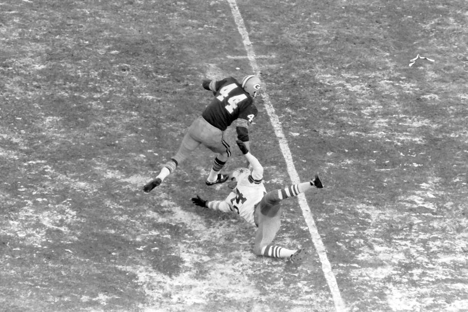 Packers running back Donny Anderson and Cowboys linebacker Chuck Howley try to maneuver on the frozen turf of Lambeau Field during the NFL Championship Game, Dec. 31, 1967, in Green Bay Wis. The Packers won 21-17.