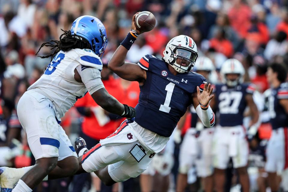 Auburn quarterback TJ Finley (1) throws a pass for a first down.