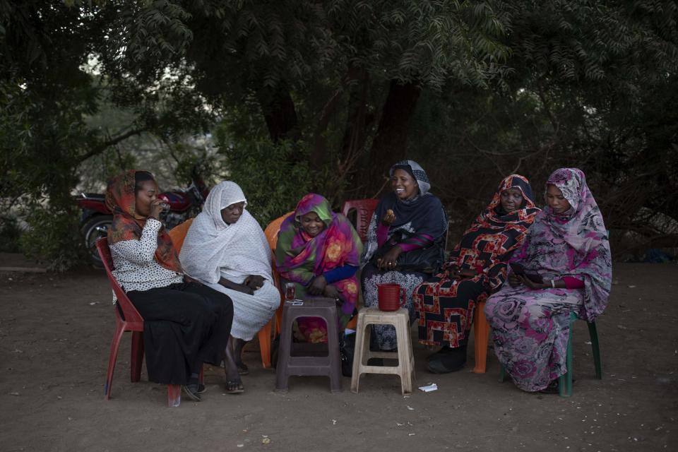 In this Jan. 12, 2020 photo, the head of the Women Tea Vendors’ Union, Awadia Coco, second left, sits with other members of the union, which supports women’s rights, as they drink tea on a street in Khartoum, Sudan. Many tea vendors were sexually assaulted during the June 3, 2019 crackdown on a protest camp in Khartoum. The Associated Press spoke to six rape victims. They told similar stories of Rapid Support Forces fighters corralling up fleeing protesters, beating them, sexually molesting the women and gang-raping some. (AP Photo/Nariman El-Mofty)