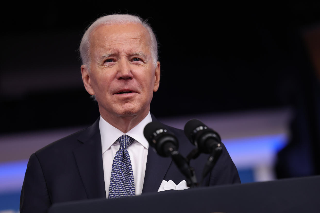 President Biden at the microphone, looking a little wary.