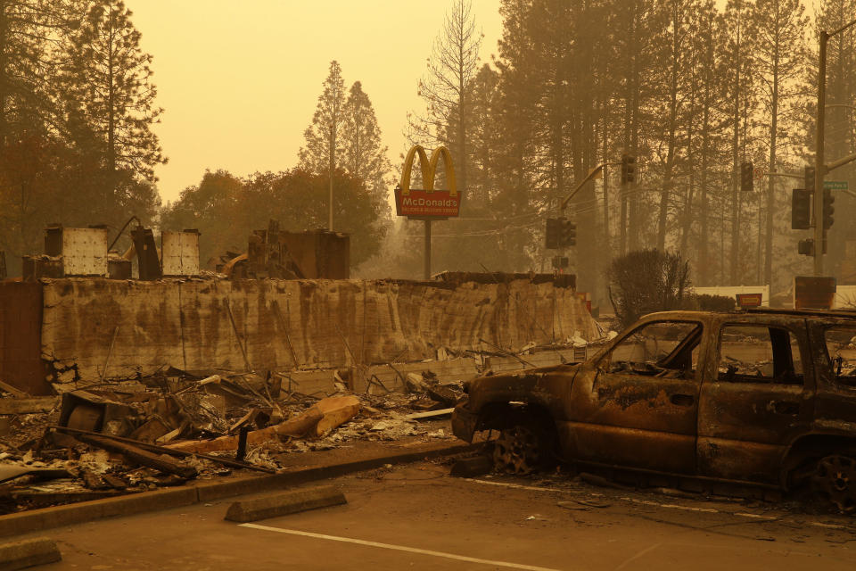 FILE - A sign still stands at a McDonald's restaurant burned in the Camp Fire on Nov. 12, 2018, in the northern California town of Paradise. The Camp Fire bears many similarities to the deadly wildfire in Hawaii. Both fires moved so quickly residents had little time to escape. (AP Photo/John Locher, File)