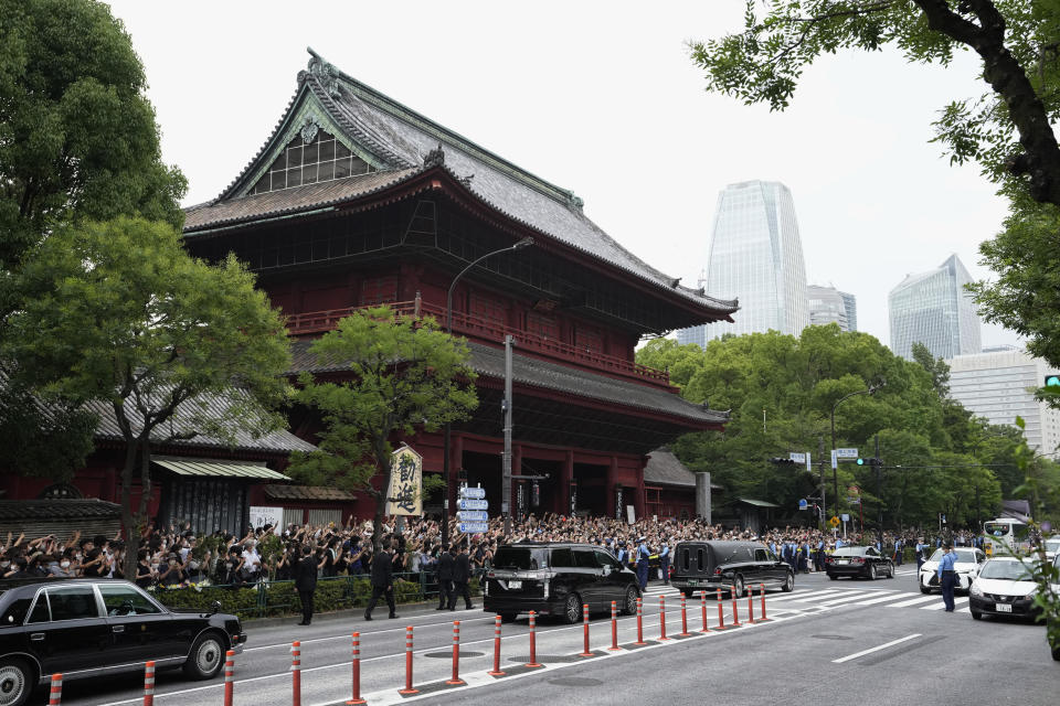 The vehicle, center right, carrying the body of former Japanese Prime Minister Shinzo Abe leaves the Zojoji Buddhist temple after his funeral in Tokyo, Japan, July 12, 2022.  / Credit: Hiro Komae/AP