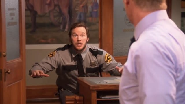 Andy in a police uniform running into the Parks Department in "Parks and Recreation"