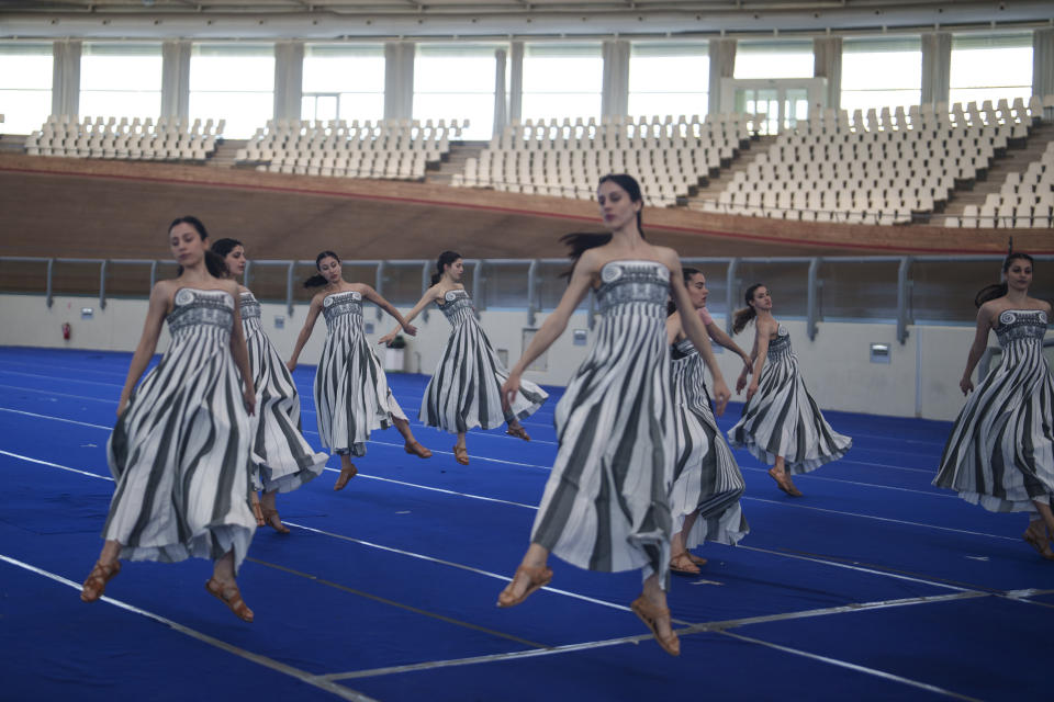 Performers, who will take part in the flame lighting ceremony for the Paris Olympics, practice at the Olympic Velodrome in Athens, Greece, Saturday, March 30, 2024. Every two years, a countdown to the Olympic games is launched from its ancient birthplace with a flame lighting ceremony in southern Greece at Ancient Olympia. The event is marked with a performance by dancers who assume the role of priestesses and male companions, their movement inspired by scenes on millennia-old artwork. (AP Photo/Petros Giannakouris)