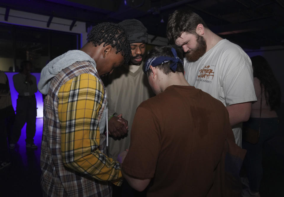 Young clubbers at The Cove, a pop-up, 18-and-up Christian nightclub, pray together after a night of dancing on Saturday, Feb. 17, 2024, in Nashville, Tenn. (AP Photo/Jessie Wardarski)