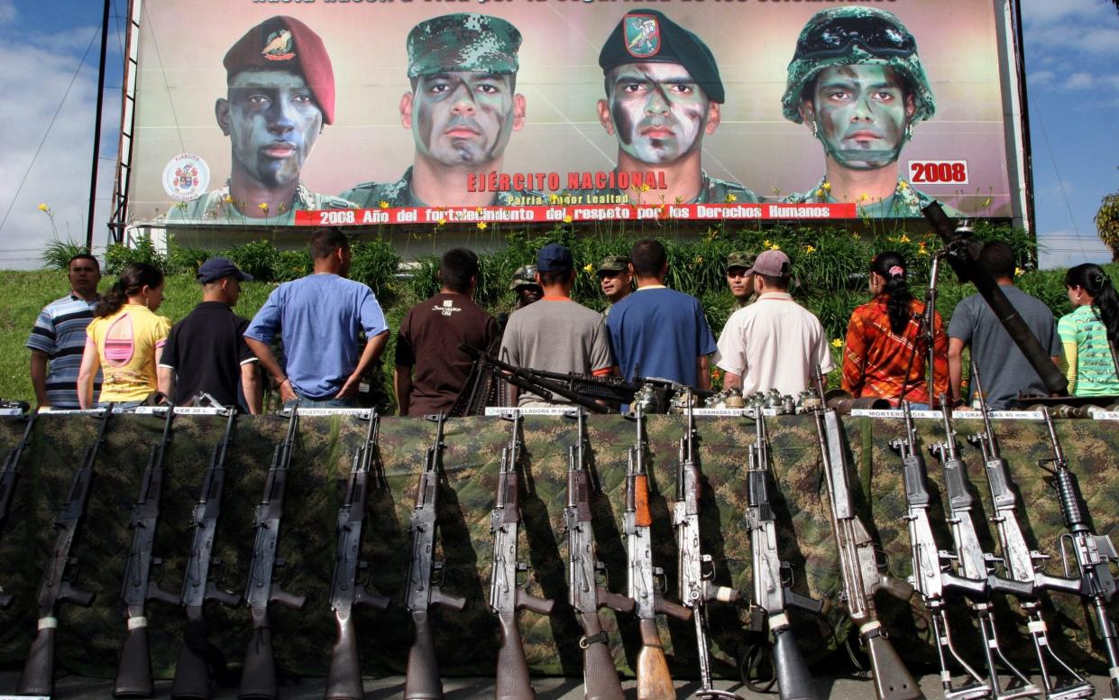 Members of the Revolutionary Armed Forces of Colombia (FARC) surrender their weapons to the Colombian Army - RAUL ARBOLEDA/AFP/Getty Images