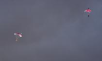 <p>Skydivers dressed as Queen Elizabeth II (left) and James Bond (right) parachuted over the Opening Ceremony arena in London. (AP) </p>