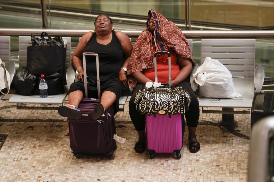 Passengers sleep waiting for their train at Milan central station during a national train strike, Thursday, July 13, 2023. Trenitalia and Italo train workers are on strike to demand better working conditions and training. in Milan, Italy, Thursday, July 13, 2023. (AP Photo/Luca Bruno)