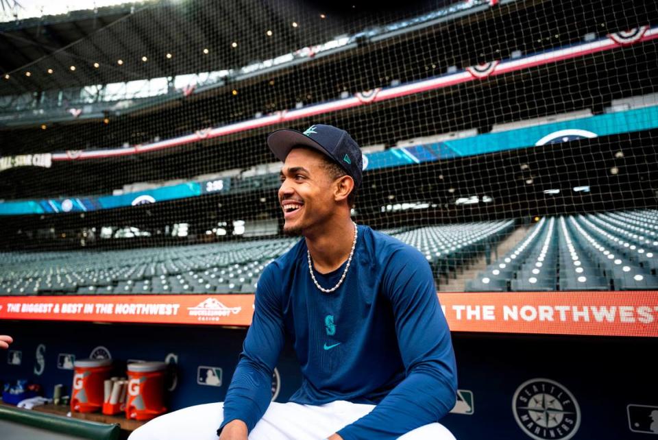 Seattle Mariners center fielder Julio Rodriguez (44) sits behind the dugout before the start of the Mariners home opener against the Cleveland Guardians at T-Mobile Park in Seattle on Thursday, March 30, 2023.