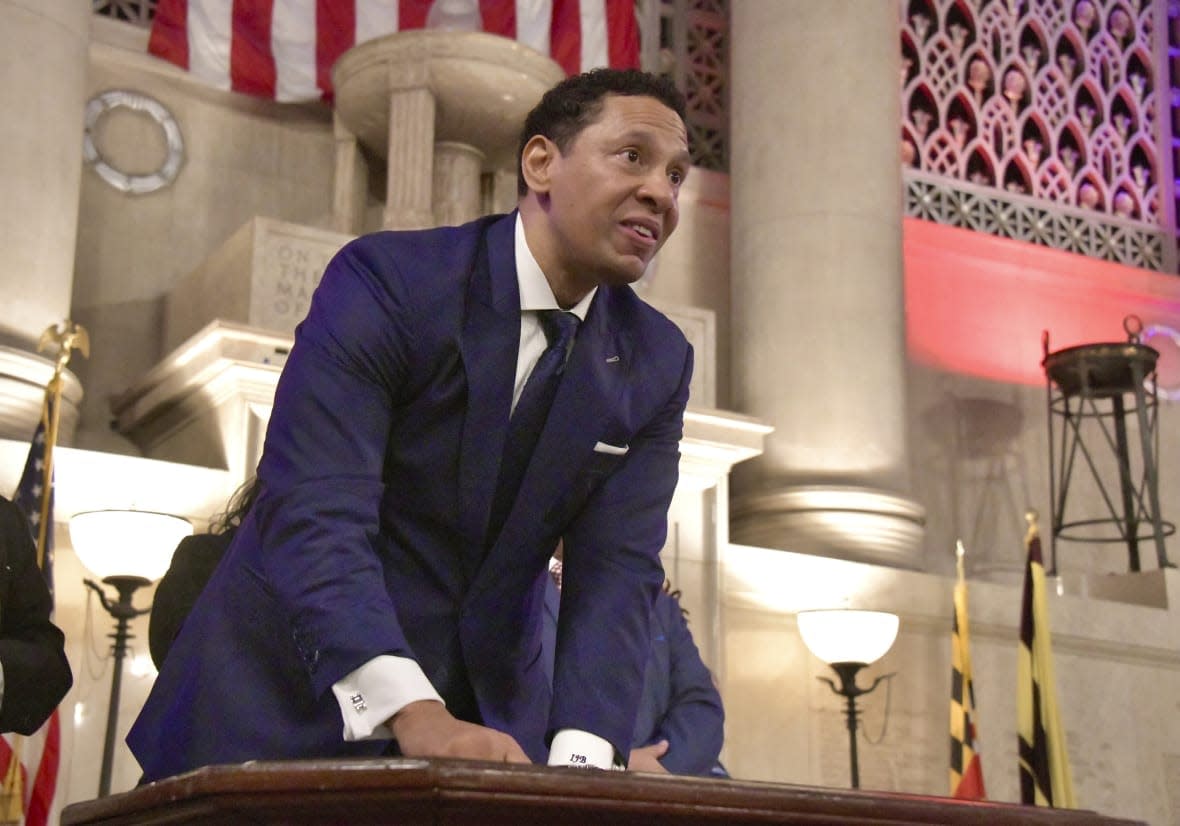 Ivan Bates looks up after adding his signature, to acknowledge the thunderous applause in the packed War Memorial Building upon his becoming Baltimore City’s new State’s Attorney, Tuesday, Jan. 3, 2023, in Baltimore. (Amy Davis/The Baltimore Sun via AP)