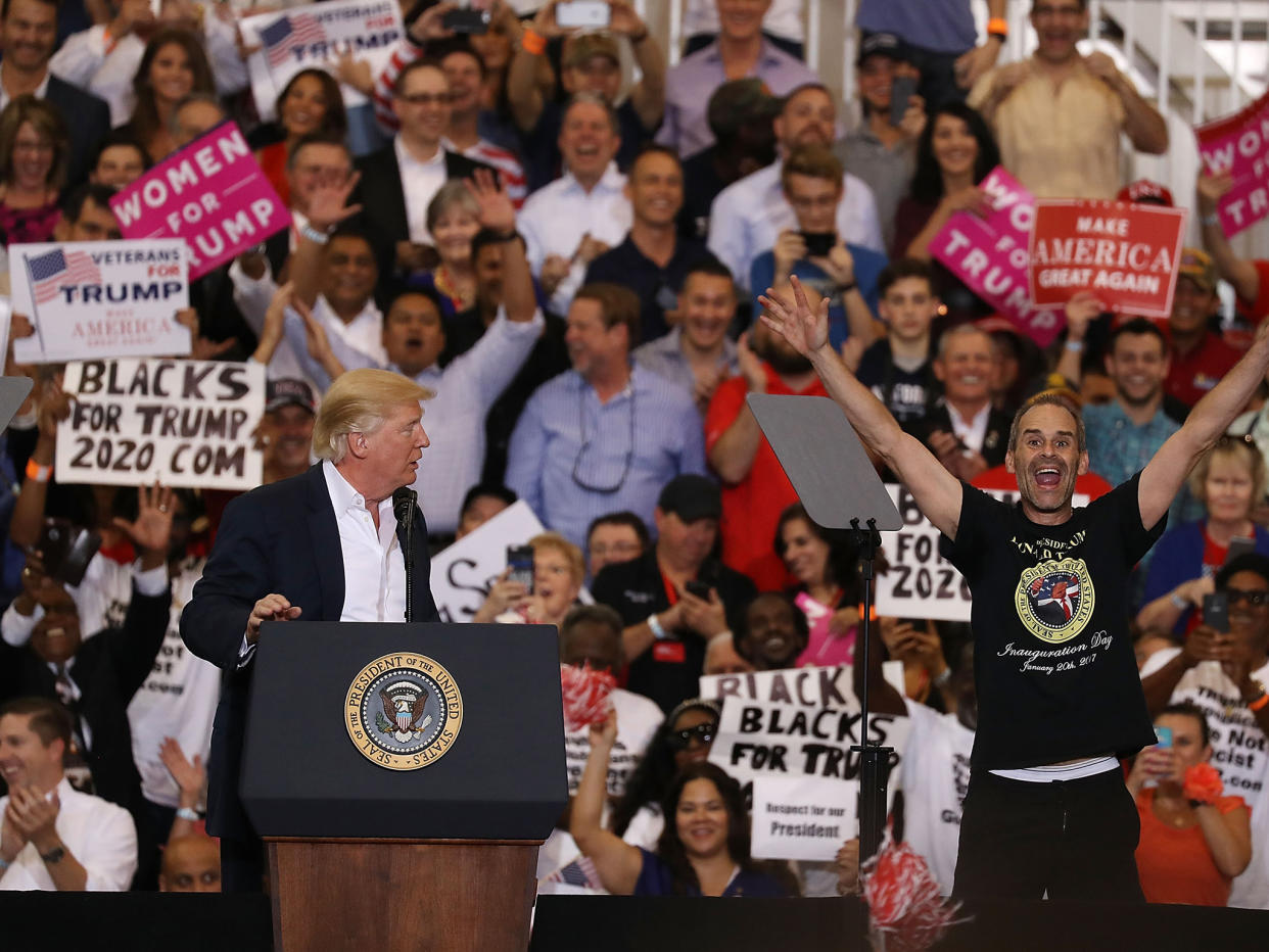 Blacks for Trump supporters waving placards behind Donald Trump during a rally in Florida last weekend: Joe Raedle/Getty Images