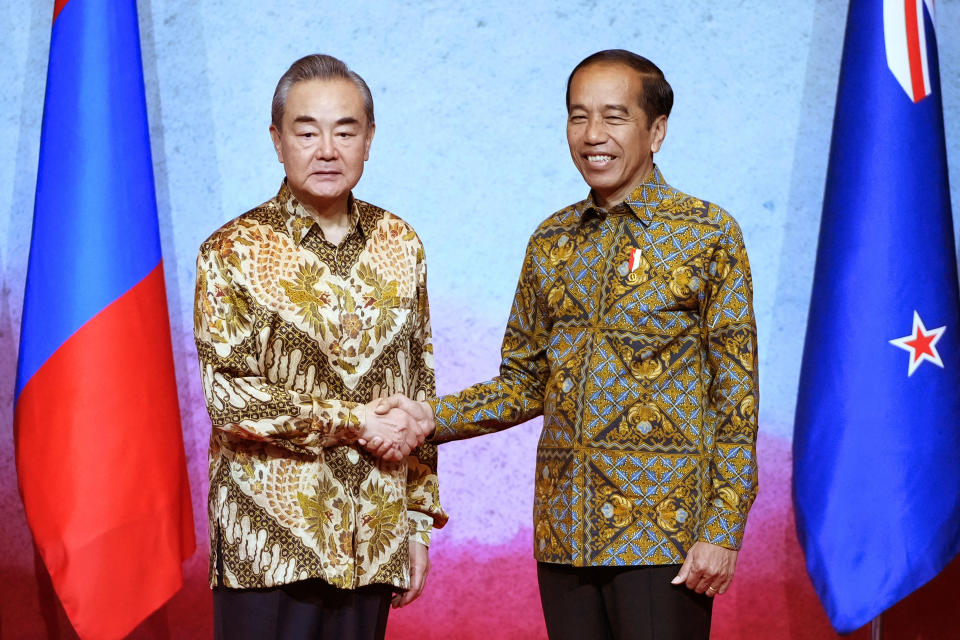 Indonesian President Joko Widodo, right, shakes hands with Chinese Communist Party's foreign policy chief Wang Yi during the courtesy calls of ministers at the Association of Southeast Asian Nations (ASEAN) Foreign Ministers' Meeting in Jakarta, Indonesia, Friday, July 14, 2023. (AP Photo/Achmad Ibrahim, Pool)