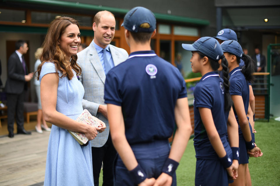 LONDON, UNITED KINGDOM - JULY 14: Catherine, Duchess of Cambridge and Prince William, Duke of Cambridge meet ballboys and ballgirls  (right to left) Tom Hubner, 15, Rhianne Black, 14, Kayleigh Man, 13 and Cassius Hayman, 15, ahead of the Men's Singles Final on day thirteen of the Wimbledon Championships at the All England Lawn Tennis and Croquet Club, Wimbledon on July 14, 2019, in London, England. (Photo by Victoria Jones - WPA Pool/Getty Images)