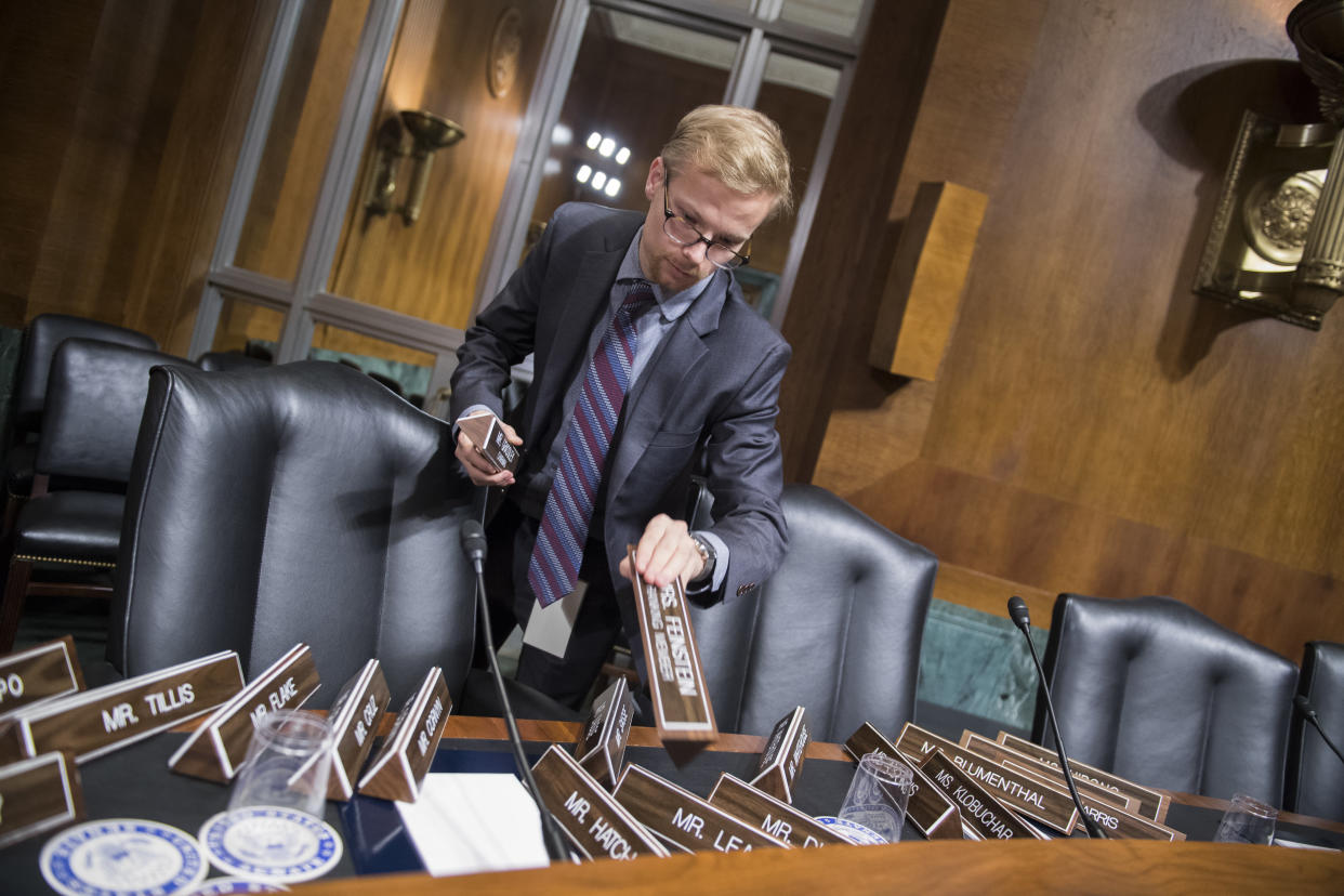 A Senate staffer arranges nameplates in the Senate Judiciary Committee hearing room on Sept. 26, 2018. (Photo: Tom Williams via Getty Images)