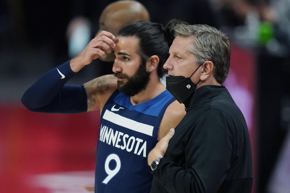 Minnesota Timberwolves guard Ricky Rubio (9) talks with head coach Chris Finch during the first half of an NBA basketball game against the Detroit Pistons, Tuesday, May 11, 2021, in Detroit. (AP Photo/Carlos Osorio)