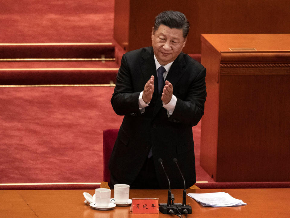 Chinese President Xi Jinping applauds veterans  at a ceremony marking the 70th anniversary of China's entry into the Korean War.