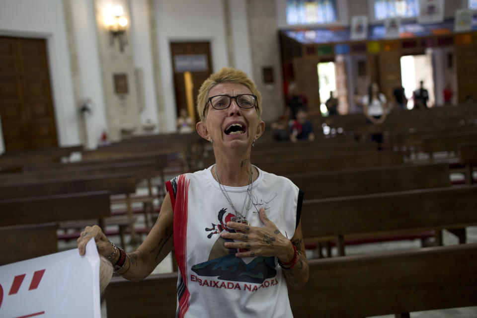 Flamengo fan Sonia Maria Mendes cries during a mass in honor for the 10 teenage soccer players who were killed by a fire at the Flamengo training center last Friday, in Rio de Janeiro, Brazil, Friday, Feb. 15, 2019. The victims were between 14 and 16 years old. Police are still investigating what caused the fire. (AP Photo/Silvia Izquierdo)