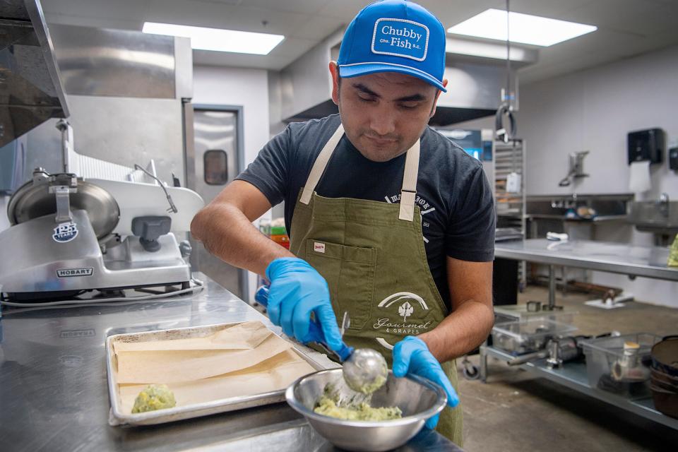 Chef Luis Martinez portions corn fritters with potato, spinach, masa and squash, February 22, 2024.