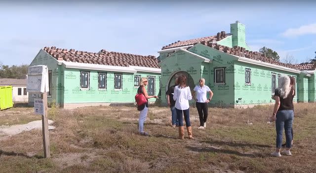 <p>First Coast News/ YouTube</p> Captain Sandy Yawn stands in front of her Florida home, which she claimed has been left unfinished by developers