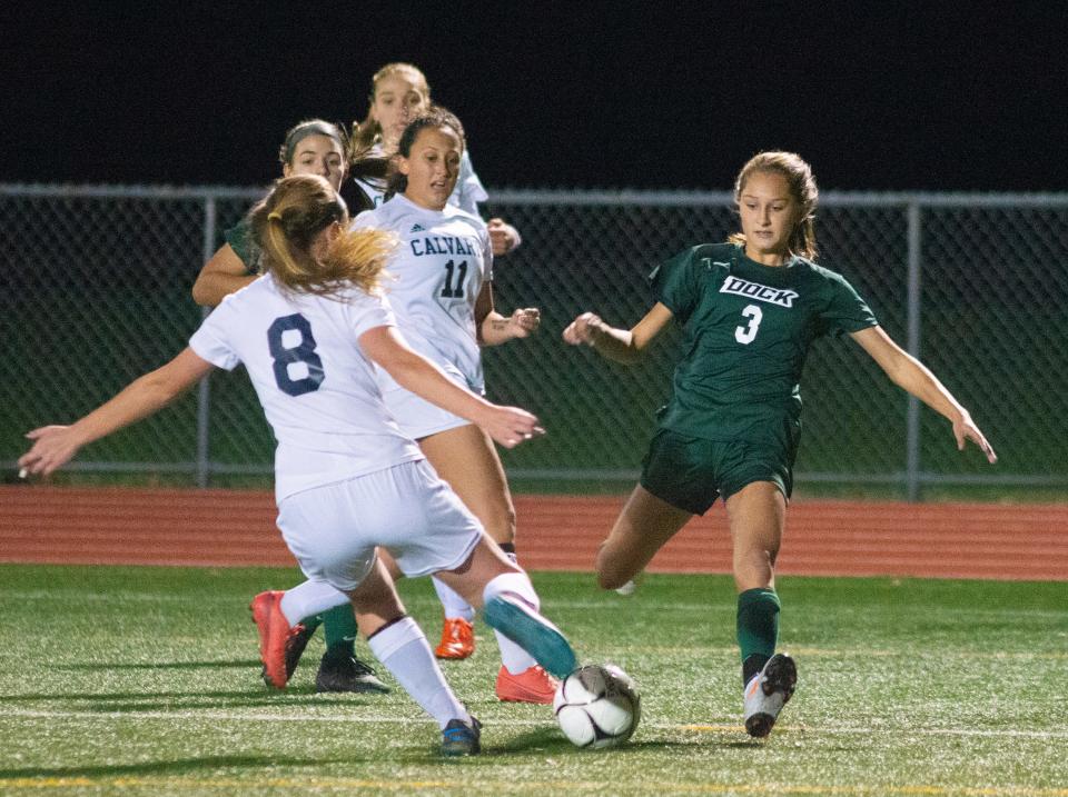 Dock’s Ashley Lapp (3) fights for a loose ball with Calvary’s Hannah Ambraham (8) and Rachel Zygarewicz (11) during the first half of the District One 1A girls soccer final Thursday, Nov. 5, 2020 in Christopher Dock. Dock won, 6-0.