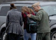 <p>A student from Great Mills High School is comforted be her guardians while being picked up at Leonardtown High School following a school shooting at Great Mills High School March 20, 2018 in Leonardtown, Md. (Photo: Win McNamee/Getty Images) </p>