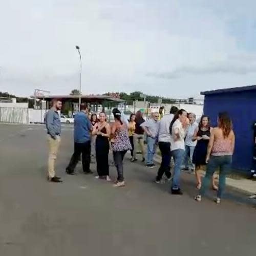 Residents gather outside during the evacuation in Noumea.