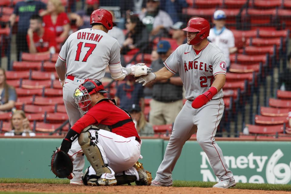 Los Angeles Angels' Shohei Ohtani (17) celebrates his two-run home run that also drove in Mike Trout (27) as Boston Red Sox's Christian Vazquez kneels at home plate during the ninth inning of a baseball game, Sunday, May 16, 2021, in Boston. (AP Photo/Michael Dwyer)