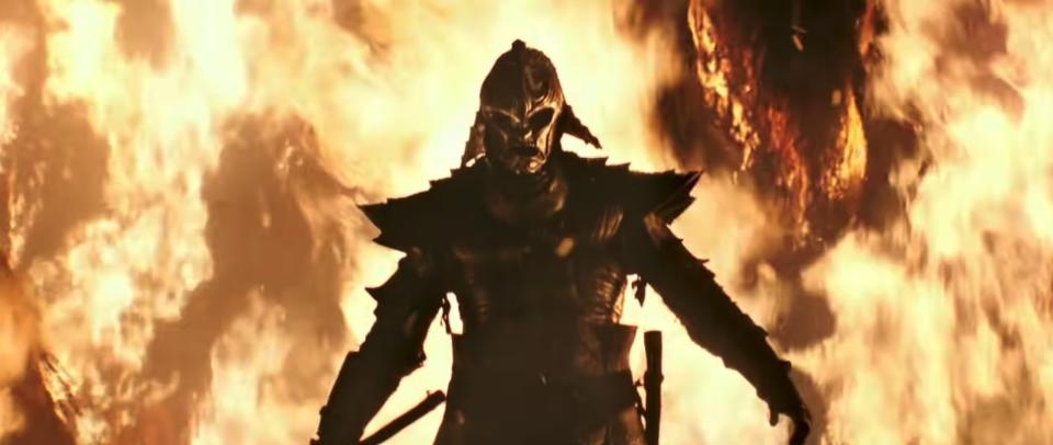 An armored figure walks out of the flames in "47 Ronin"