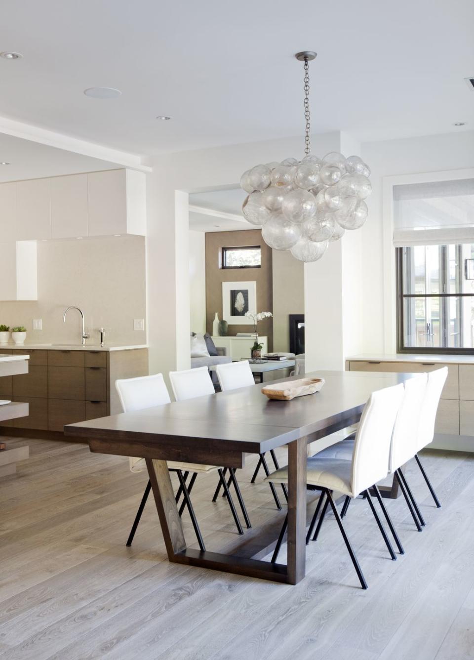 A sculptural lighting fixture adds to this stylish dining area