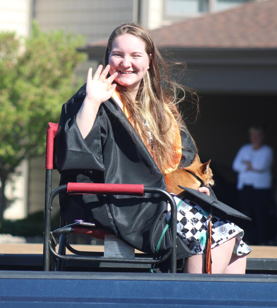 Cheboygan's Becca Blaskowski waves during Friday's senior parade in Cheboygan.