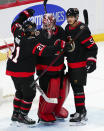 Ottawa Senators goaltender Filip Gustavsson (32) is congratulated by teammates Nick Paul (21) and Nick Holden (5) after their win over the Dallas Stars following third-period NHL hockey game action in Ottawa, Ontario, Sunday, Oct. 17, 2021. (Sean Kilpatrick/The Canadian Press via AP)