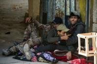 Soldiers from the Iraqi Special Forces' 2nd division point out incoming fire to comrades in a building across the road during fighting with Islamic State group jihadists in the Arbagiah neighbourhood of Mosul on November 12, 2016