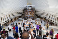 <p>Passersby take photos of the ‘Up Close: Michelangelo’s Sistine Chapel’ re-creation exhibit June 22, 2017, at the Oculus at Westfield World Trade Center in New York. The exhibit features 34 reproductions, including “The Creation of Adam” and “The Last Judgement.” (AP Photo/Michael Noble Jr.) </p>