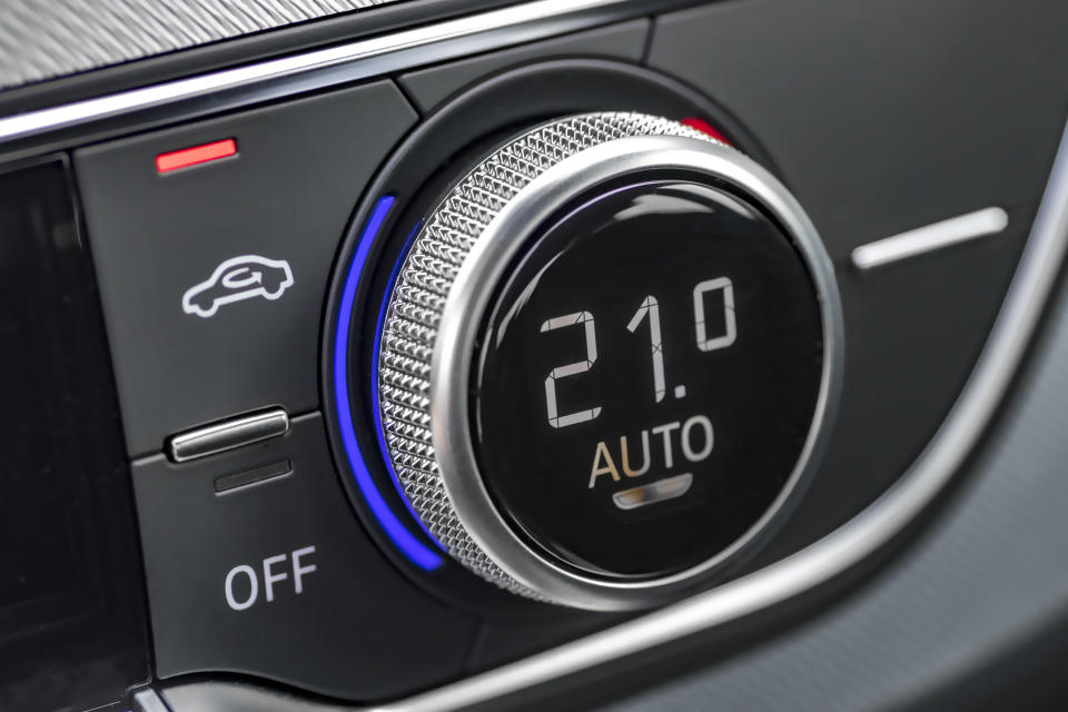 Close-up shot of a car's air-conditioning control knob and air recirculation button 