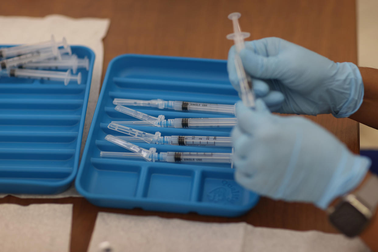 A healthcare worker prepares Moderna COVID-19 vaccines at a clinic set up by Healthcare Network on May 20, 2021 in Immokalee, Florida. (Joe Raedle/Getty Images)