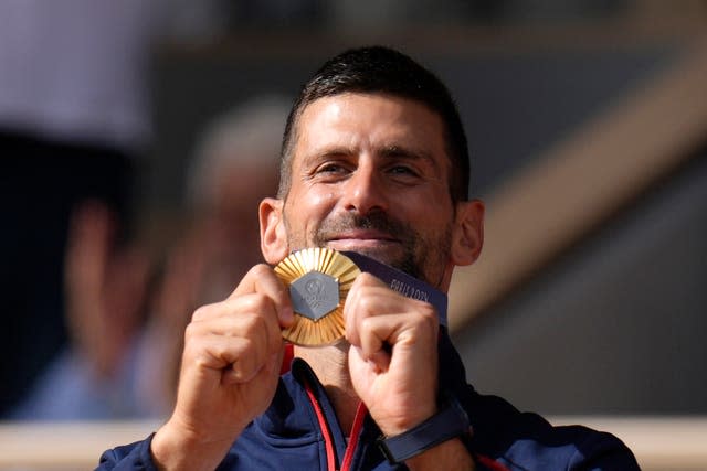 Novak Djokovic shows off his gold medal