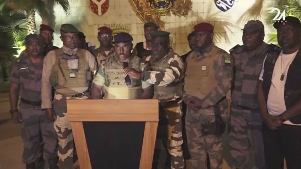 Military officers announce the seizure of government from Gabonese President Ali Bongo Ondimba in Libreville on Wednesday.  - GABON 24/AP