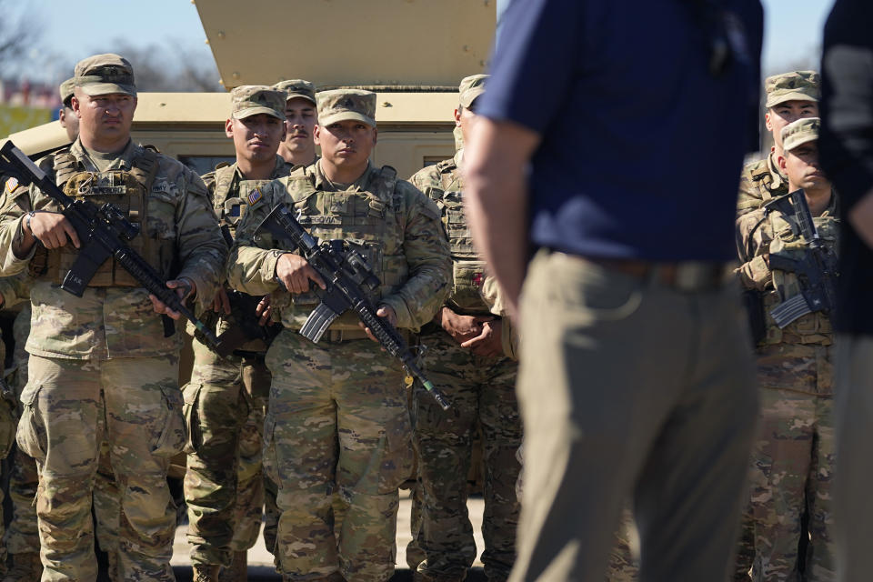 Members of the National Guard stand as Texas Gov. Greg Abbott and fellow governors hold a news conference along the Rio Grande to discuss Operation Lone Star and border concerns, Sunday, Feb. 4, 2024, in Eagle Pass, Texas. Abbott returned to the Eagle Pass border to highlight his escalating attempts to curb illegal crossings on the U.S.-Mexico border. He was joined Sunday afternoon by more than a dozen other GOP governors, all of whom have cheered on his extraordinary showdown with the Biden administration over immigration enforcement. (AP Photo/Eric Gay)