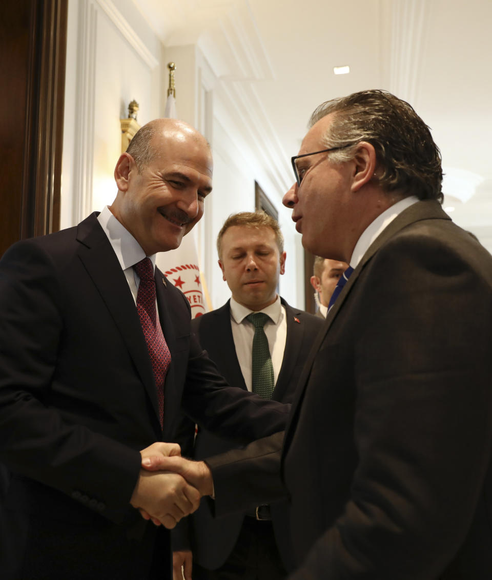 Turkey's Interior Minister Suleyman Soylu, left, shakes hands with George Koumoutsakos, right, Greece's Alternate Minister for immigration policy in the Ministry of Citizen's Protection of Greece, prior to their meeting in Ankara, Turkey, Thursday, Oct. 3, 2019.Soylu is scheduled to have a meeting later on Thursday with his French and German counterparts on the EU-Turkey migration agreement and supporting EU-member Greece in coping with migrant arrivals. (AP Photo/Ali Unal)
