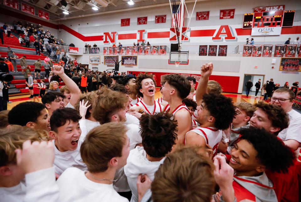 The Nixa Eagles celebrate with the student section after they beat the Republic Tigers during a game on Tuesday, Feb. 7, 2023. 