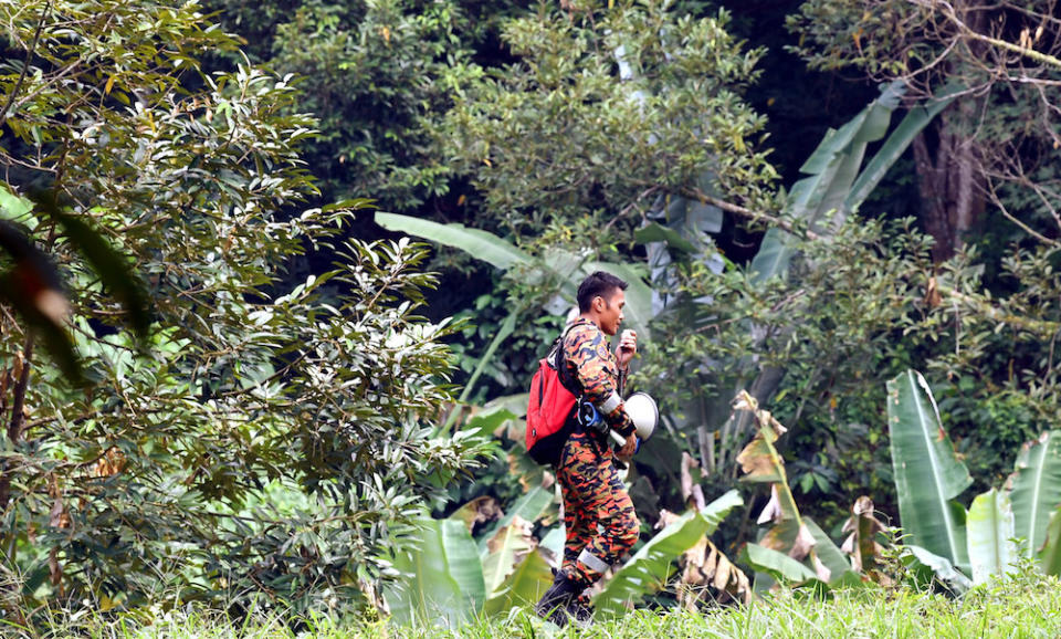 A rescuer holds a bullhorn while participating in the search for missing Irish teen Nora Anne Quoirin in the jungle near Seremban August 9, 2019. — Bernama pic